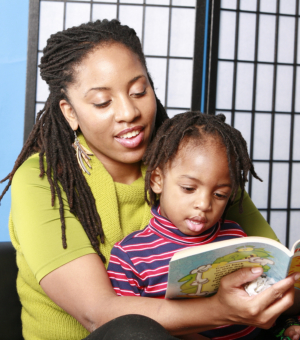 woman with her child readying book